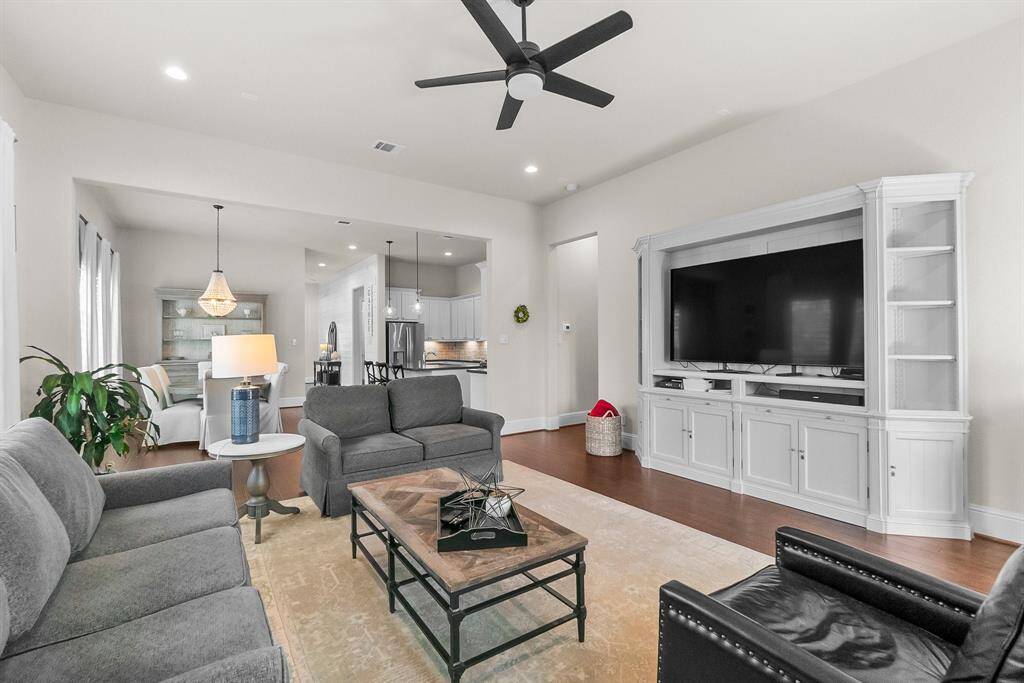 Spacious living area, a large entertainment center seamlessly connects to the dining and kitchen areas, perfect for entertaining.