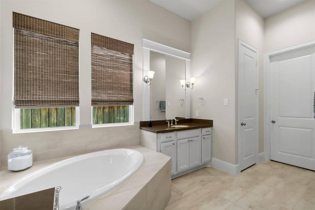 Primary bath includes convenient linen and primary bedroom closets.