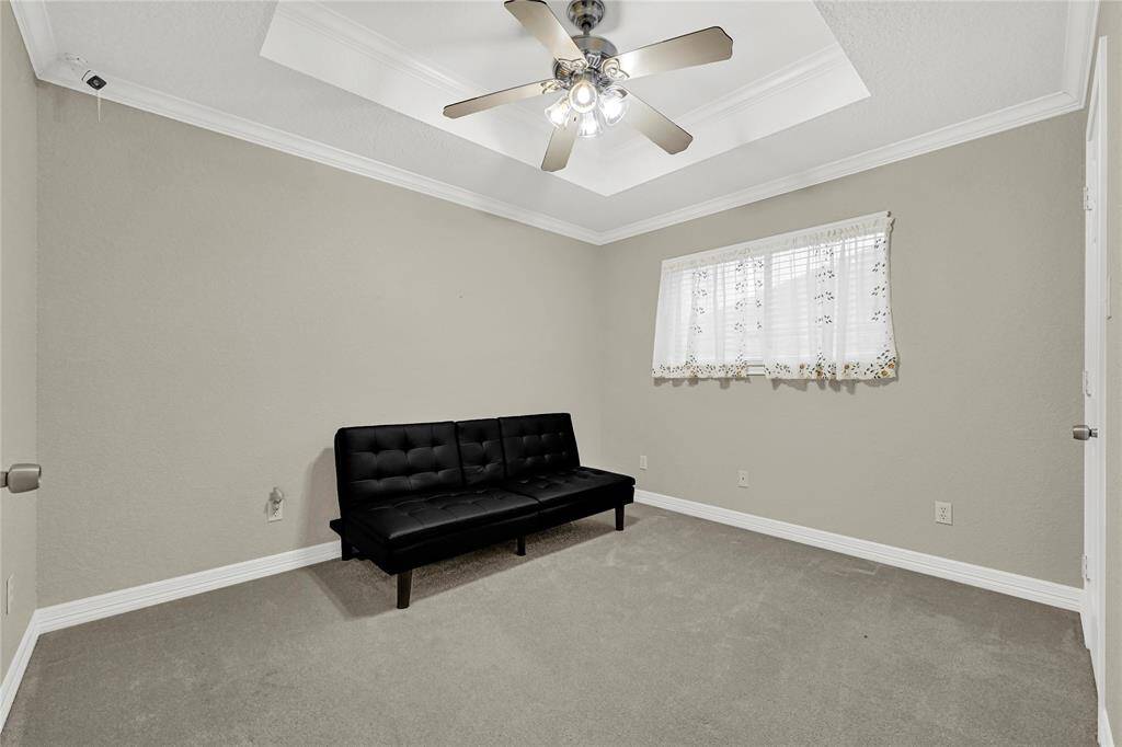 The spacious secondary bedroom offers plenty of room for comfort and versatility. Whether used as a guest room, home office, or personal retreat.