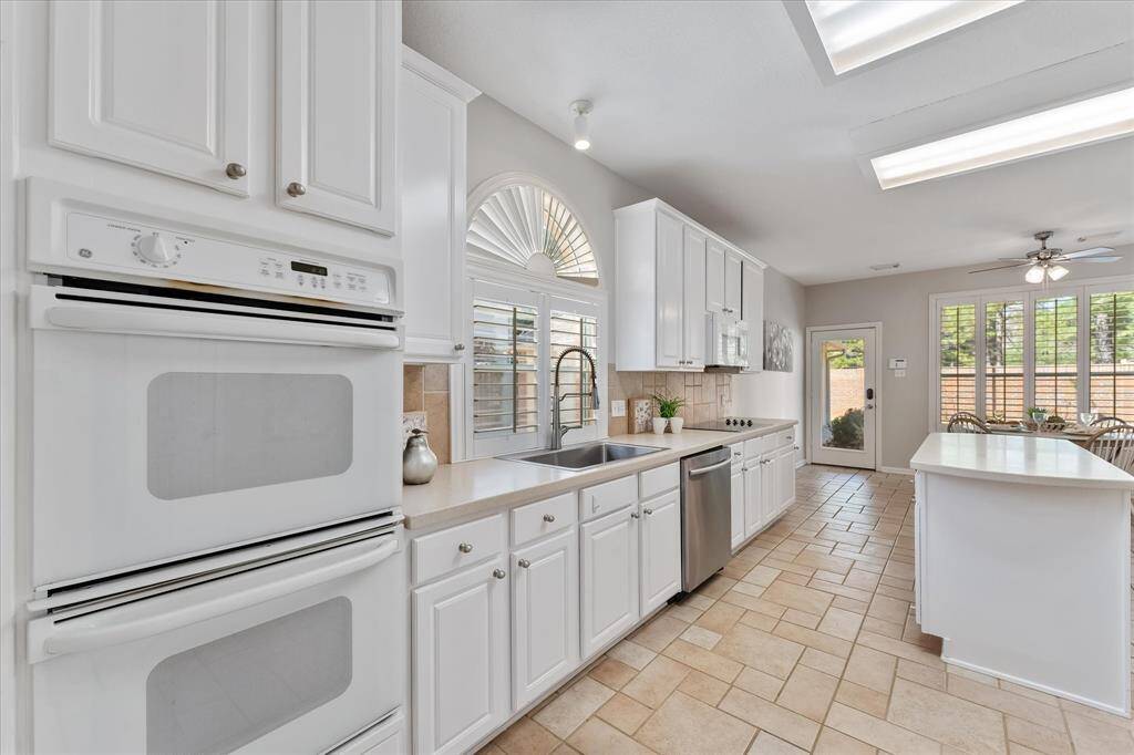 Light and bright kitchen with recently painted cabinets, new stainless sink and faucet, chef's island and an abundance of cabinets for storage.  Gas connections under cabinet of cooktop.