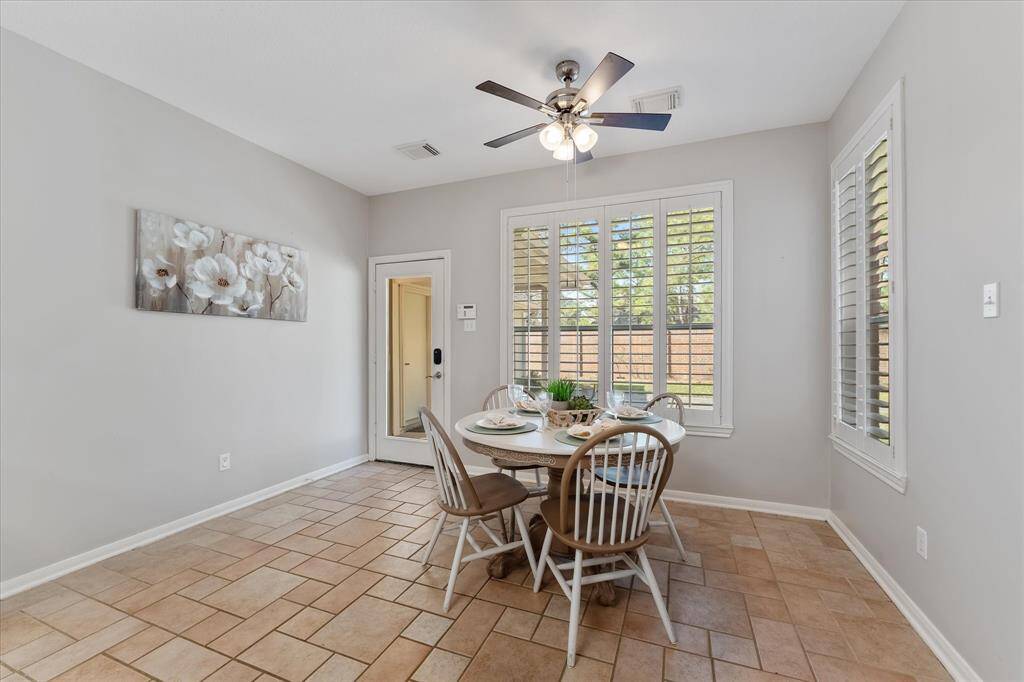 Breakfast room with plantation shutters and a view of the beautiful back yard.
