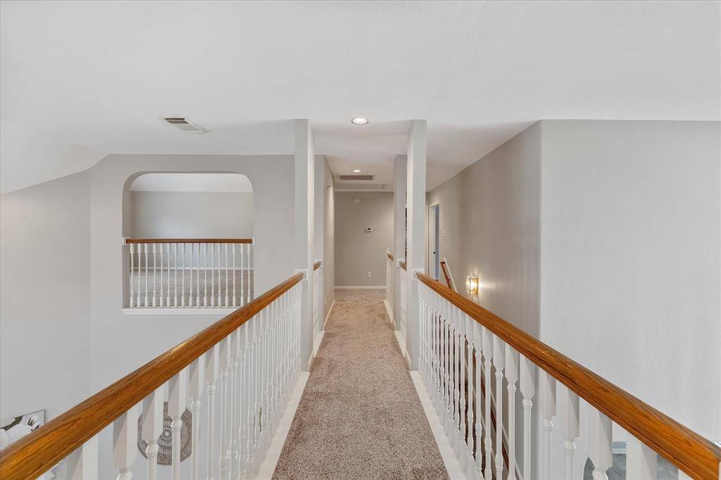 Upstairs catwalk hallway with a view of the living room and large gameroom.