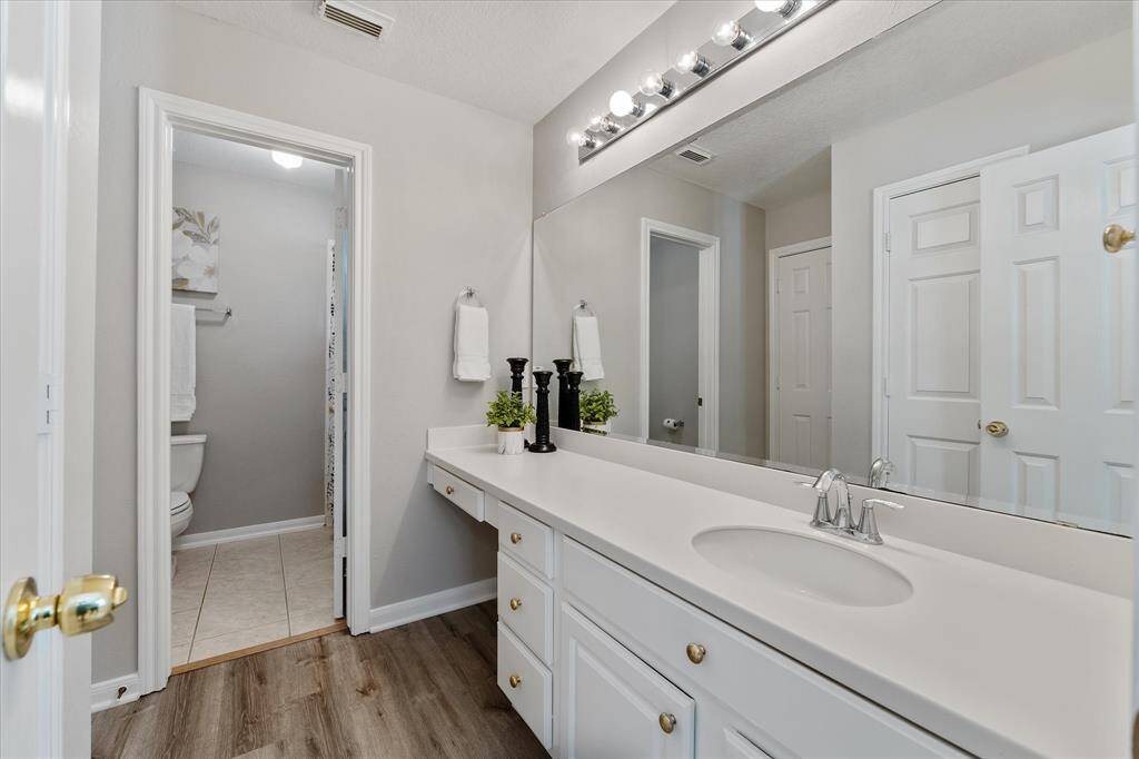 Secondary bathroom with freshly painted cabinets, doors and trim