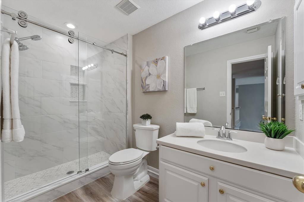 Updated bath with large walk in shower and freshly painted vanity, trim and door.