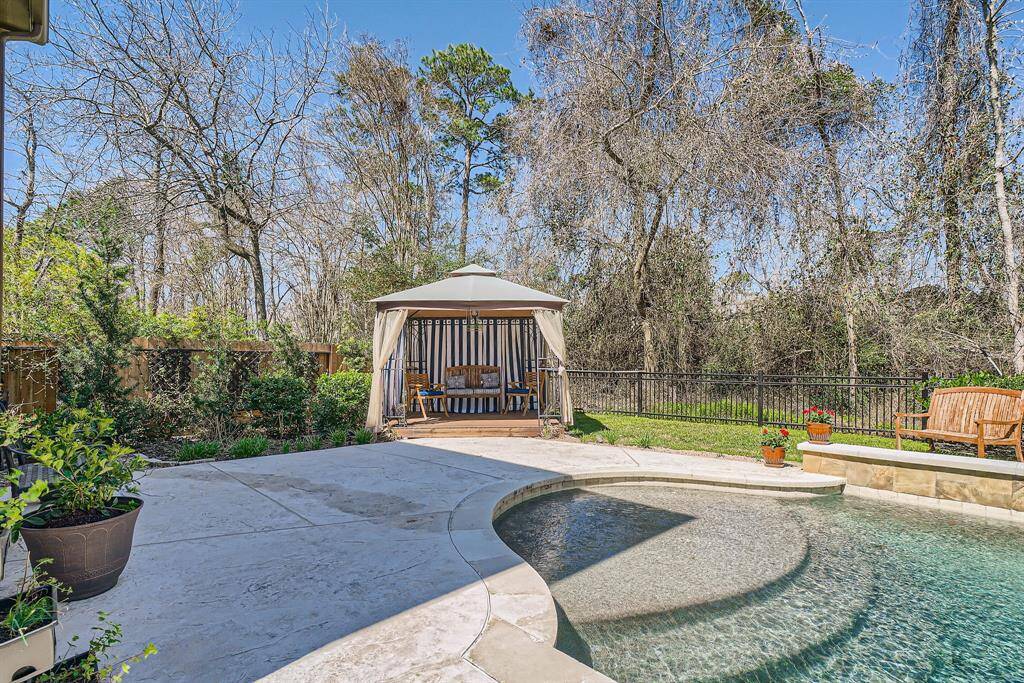 A special custom made gazebo, surrounded by lush greenery and trees, offering a peaceful and private outdoor retreat.