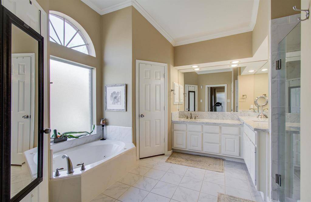 master bathroom with tub and separate shower.