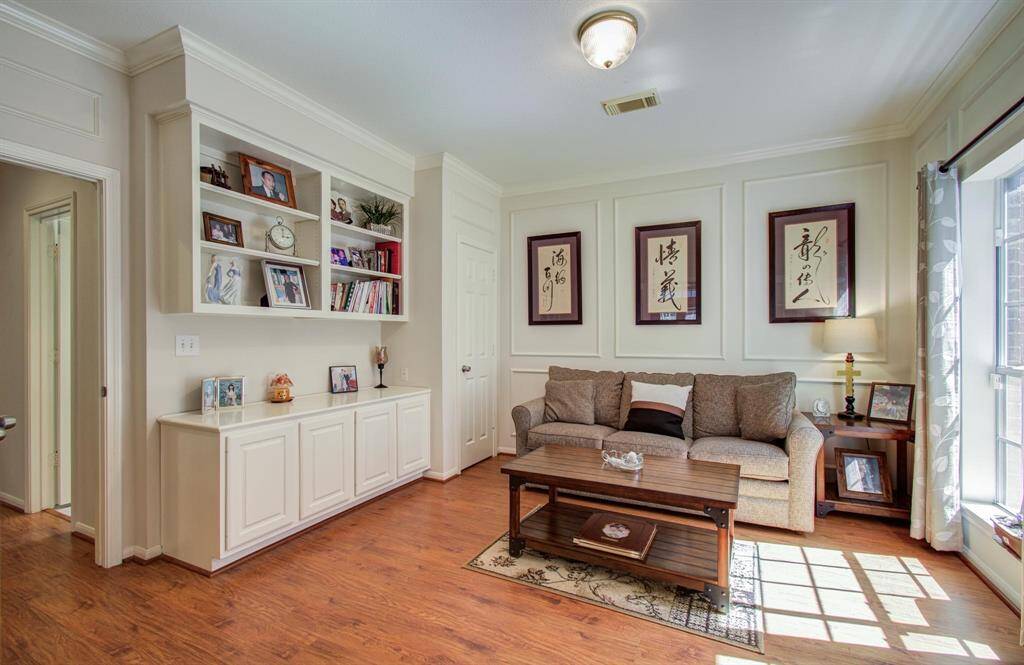 Third bedroom/study with custom built-ins and french door.