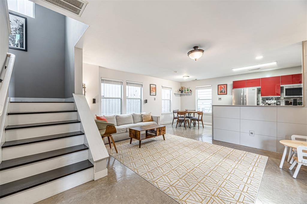 Open concept first floor living room with stained concrete floors