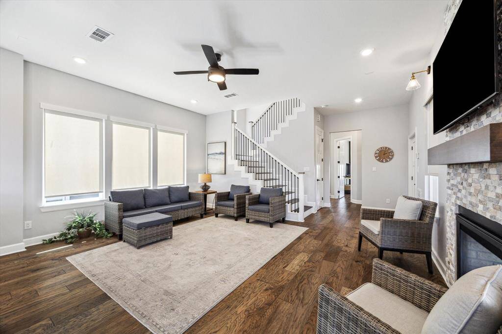 SPACIOUS DEN EVEN FEATURES SEATING ON EITHER SIDE OF THE FIREPLACE.
