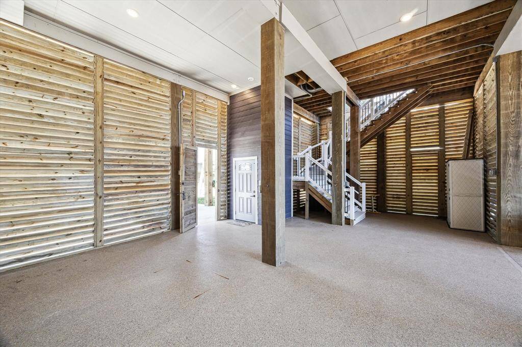 FIRST LEVEL WITH THE ELEVATOR DOOR IN THE BACKGROUND.  THE PRIVACY PANELS TO THE LEFT CAN ALSO ACCOMMODATE A GARAGE DOOR FOR ADDITIONAL GARAGE PARKING.