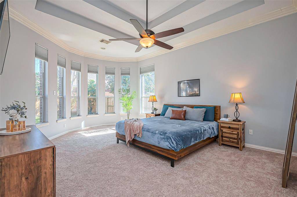 This primary bedroom features a large bay window that allows abundant natural light, creating a bright and airy feel. The carpet was replaced in 2024.