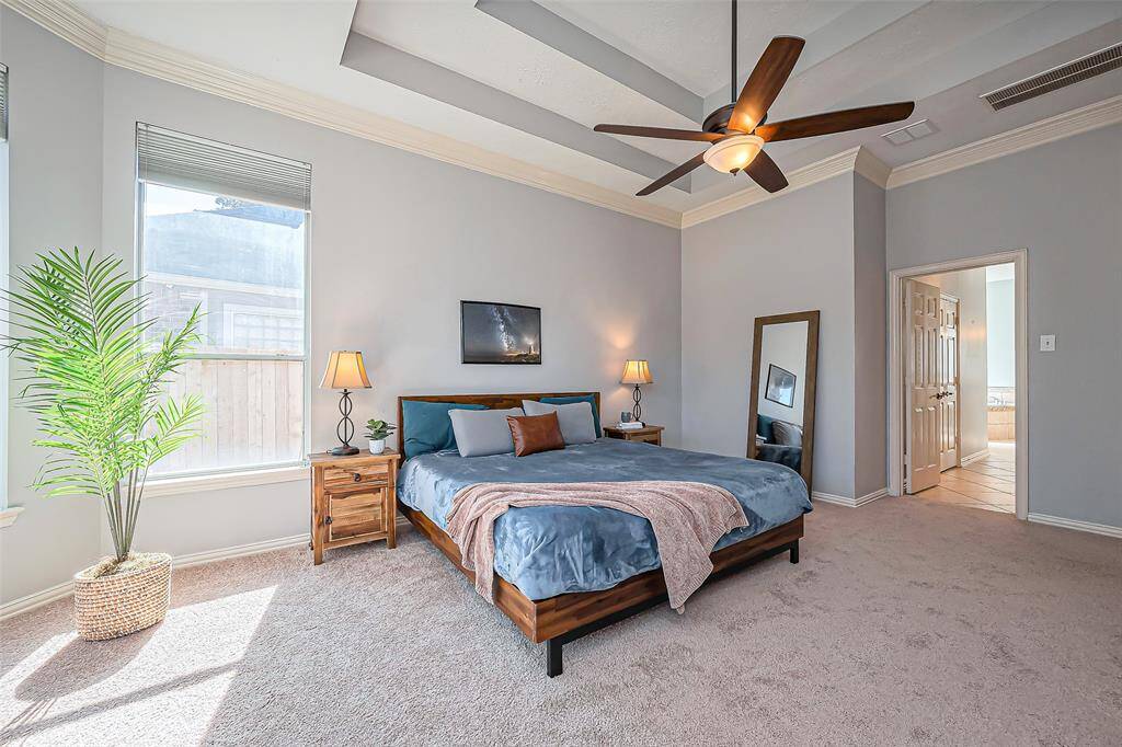 Discover the elegant primary bedroom with a stunning vaulted ceiling, seamlessly leading to a luxurious spa-like en suite.