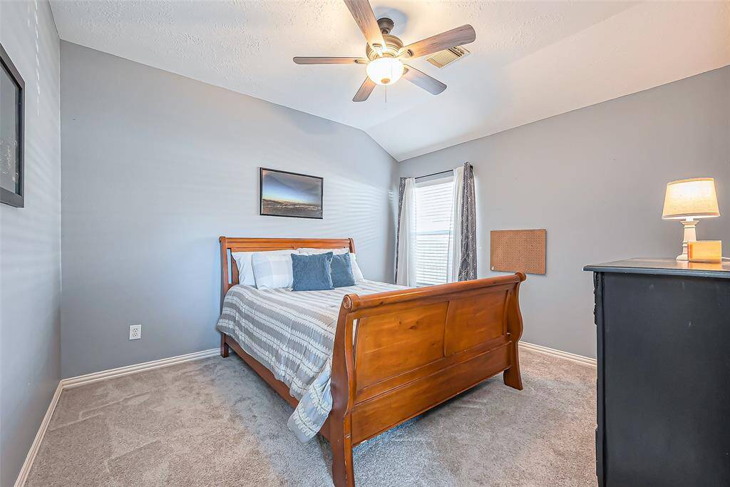 Bedroom #2 is cozy and inviting with soft gray walls, plush carpeting, and ample natural light, ideal for relaxation.