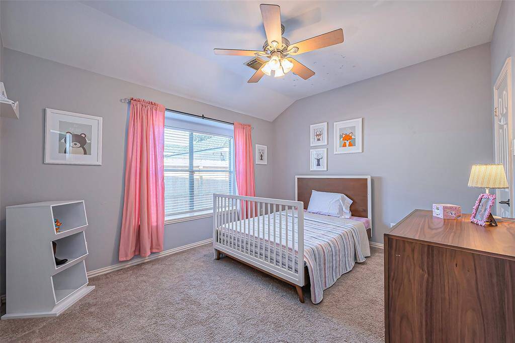 Bedroom #3 with ample natural light, perfect for a child’s room or guest space.