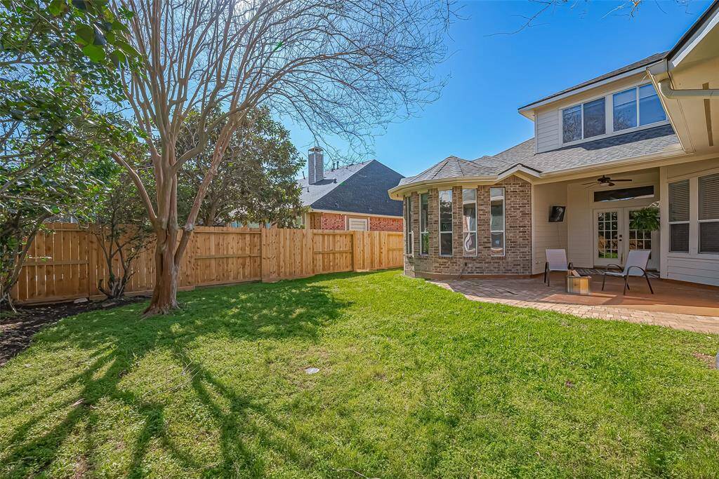 Tranquil backyard with brand-new fencing on all sides for added privacy.