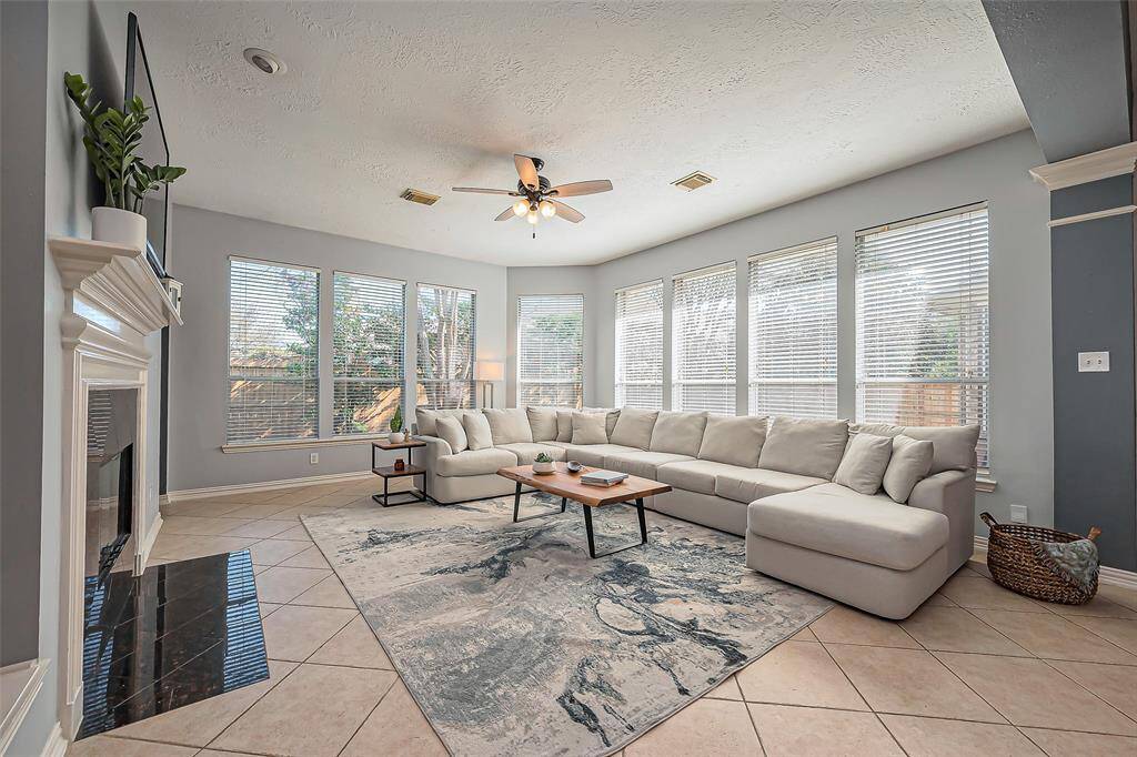 Bright, spacious living room with large windows, and space for a cozy sofa.  Large windows bring in natural light, creating an inviting atmosphere.