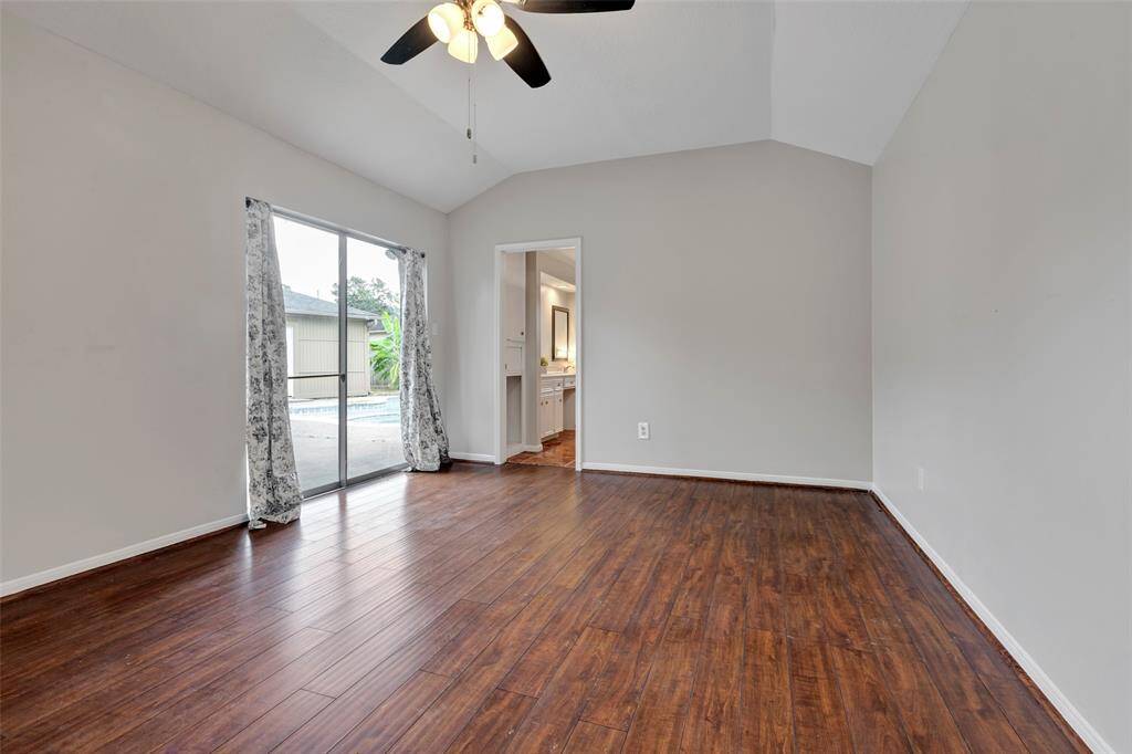 Primary Bedroom.  Sliding glass doors open to hot tub and pool.