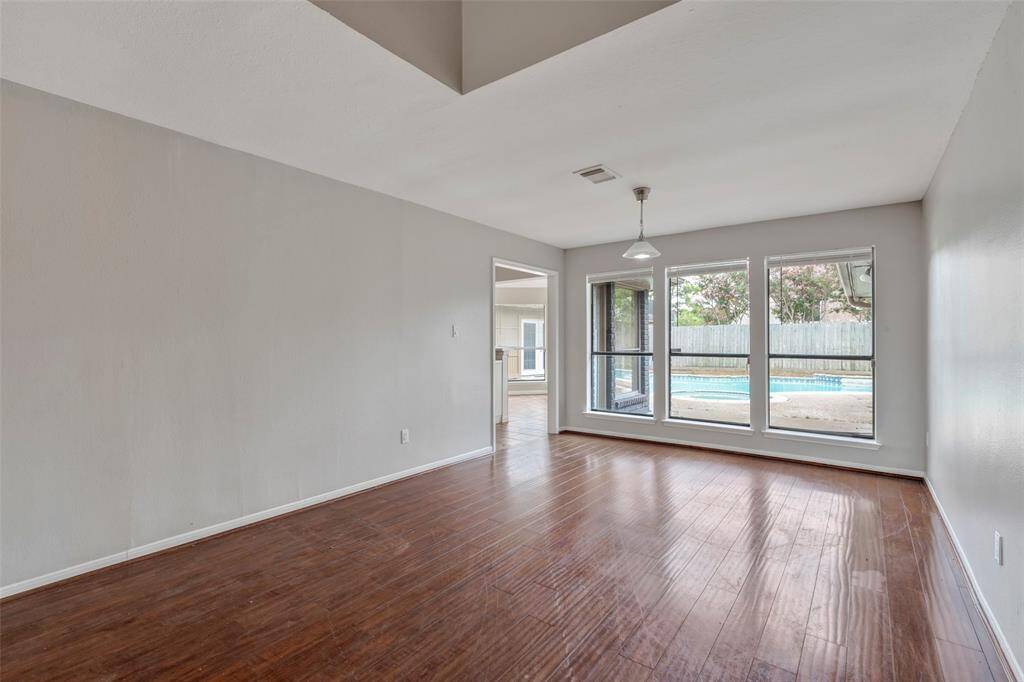 Dining room also has view of backyard and pool.