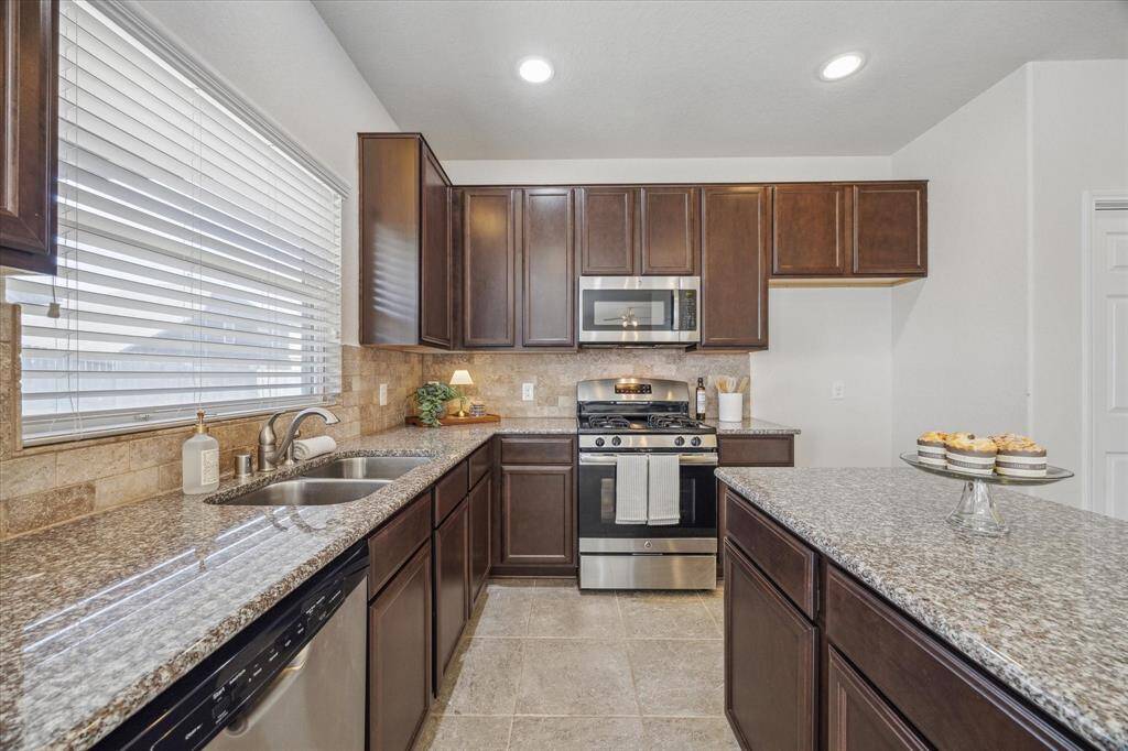 Yards of polished granite countertops provide plenty of prep and serving space.