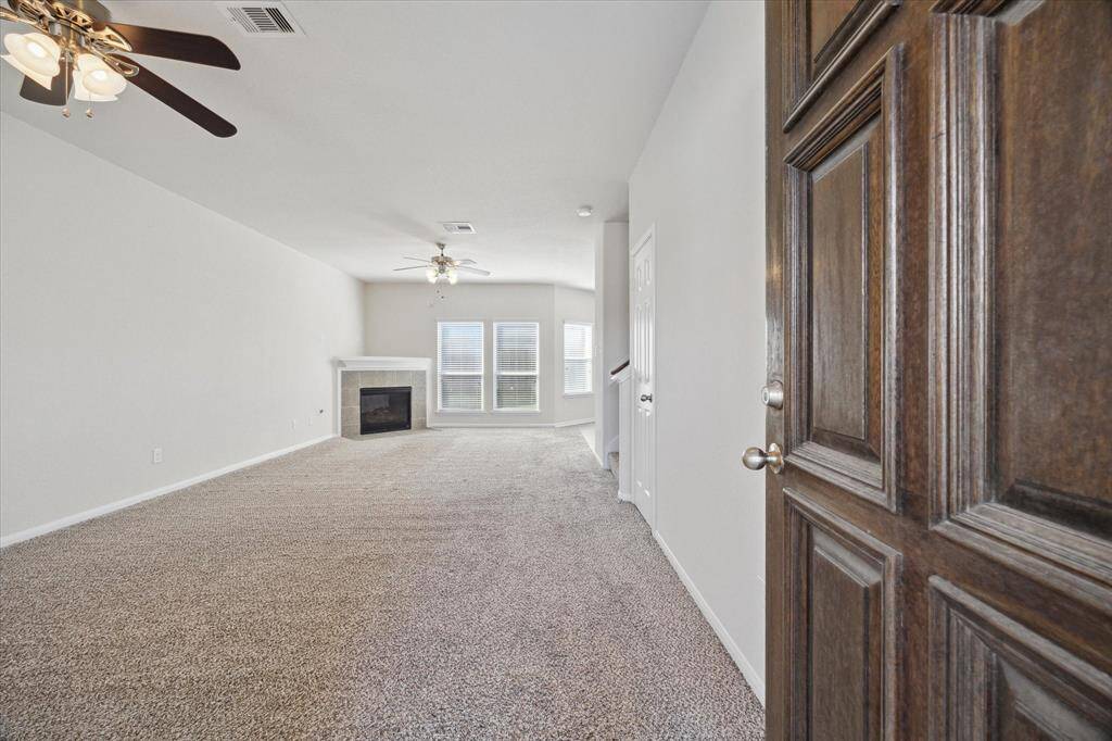 Upon entry, the open flow of the first floor shows off the large living area and gas fireplace.