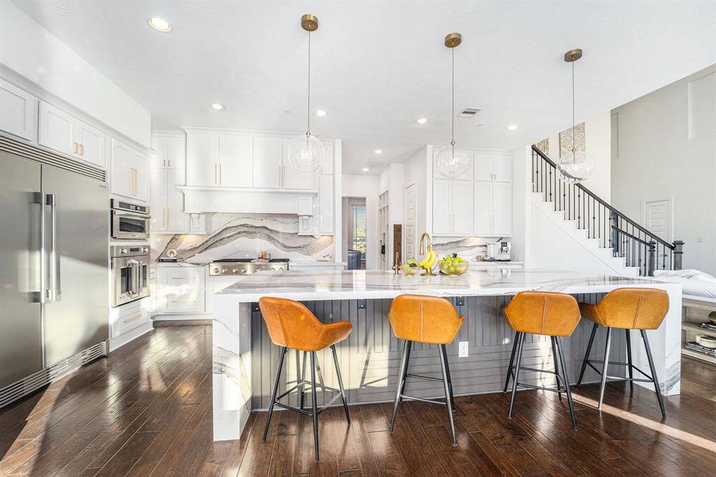 Custom Kitchen - Custom lighting, new hardware, new cabinet paint, built in state-of-the-art appliances, oversized waterfall island.  Double dishwasher, farmhouse sink with drip ledge, touchless faucet, reverse osmosis drinking water system with insta-hot, and an oversized walk-in pantry for max storage.
