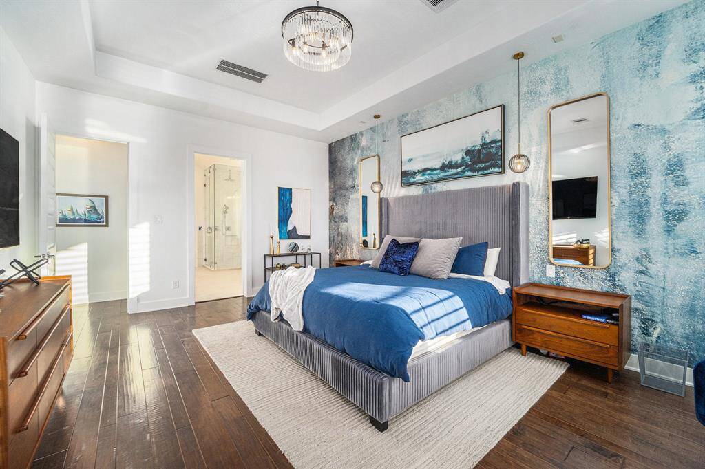 Custom lighting, wallpaper accent wall, plantation shutters, hardwood floors.