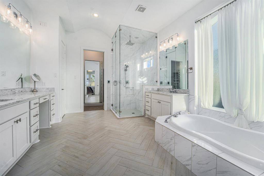 Master Bathroom - Oversized master bathroom with a steam shower, freshly tiled floors, and newly painted cabinets. Enjoy the luxury of a rainforest showerhead and custom lighting.