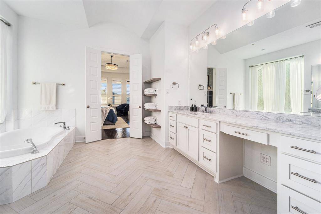 Steam shower, freshly tiled floor, newly painted cabinets, custom lighting, rainforest showerhead.