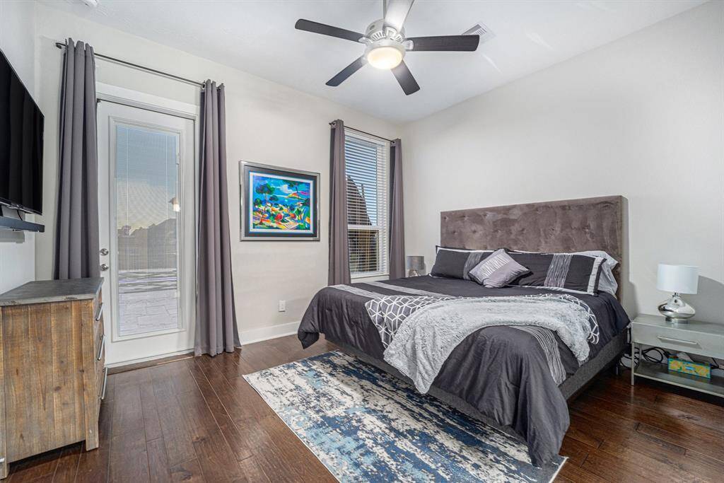 Secondary bed #1 -Downstairs mother-in-law suite offering a spacious bathroom and direct outdoor exit leading to the resort-style backyard, perfect for privacy and convenience.  Secondary bedroom 1.
