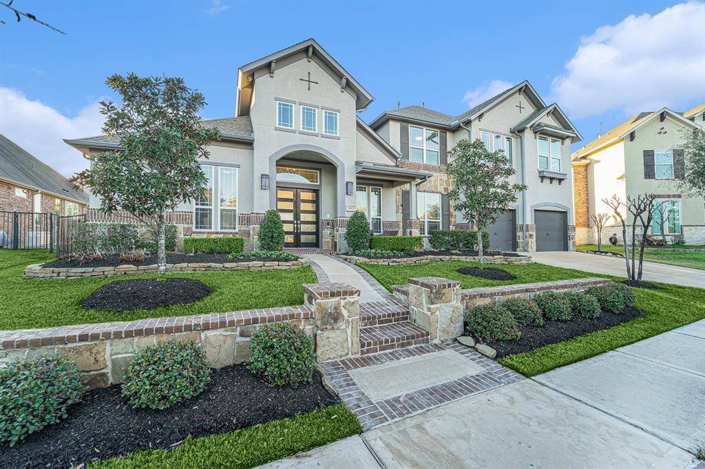 Exterior faces East showcases a combo of stucco and brick finishes, complemented by an attached 3-car tandem garage.