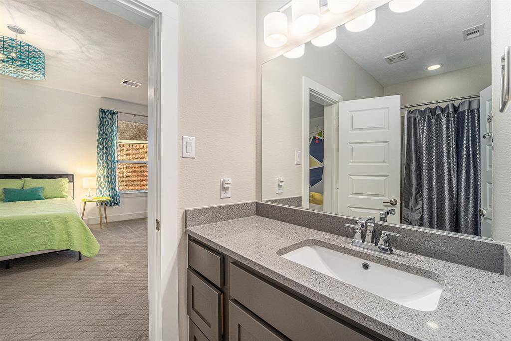 Both bathrooms have been updated with quartz countertops and upgraded tiles surrounding the tubs for a modern touch.