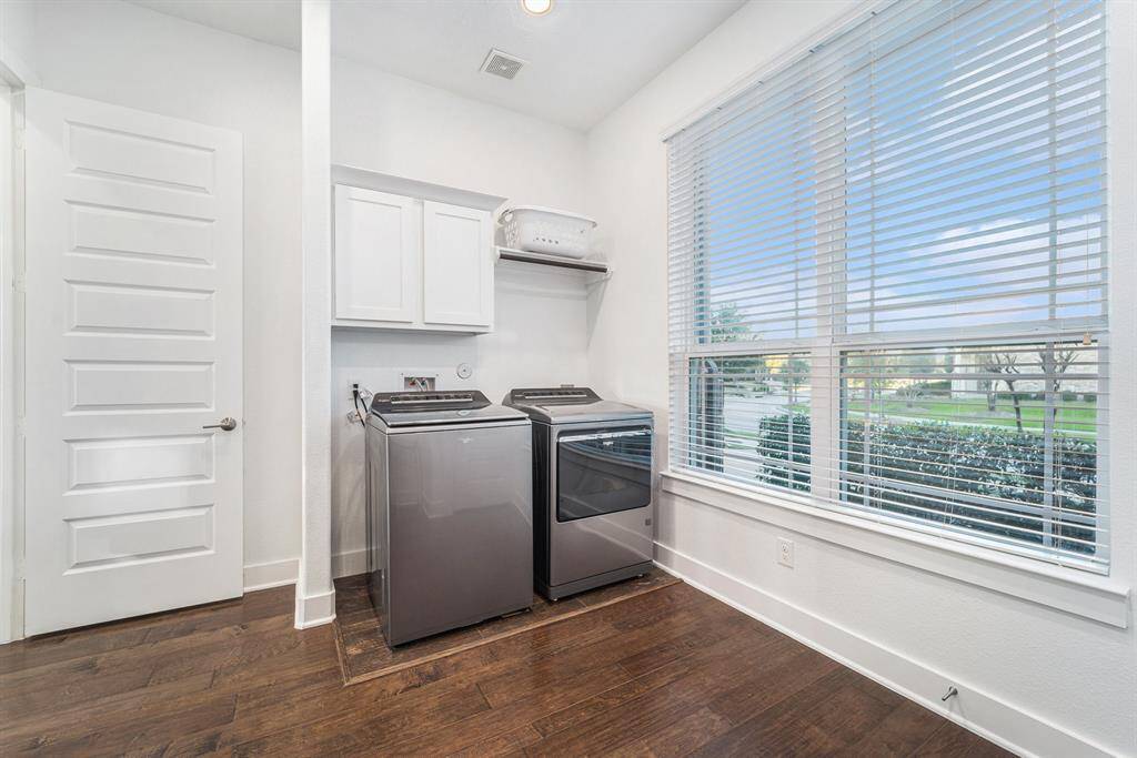 Oversized laundry room with built-in storage, additional cubbies  and a convenient coat rack, making chores more organized and efficient.