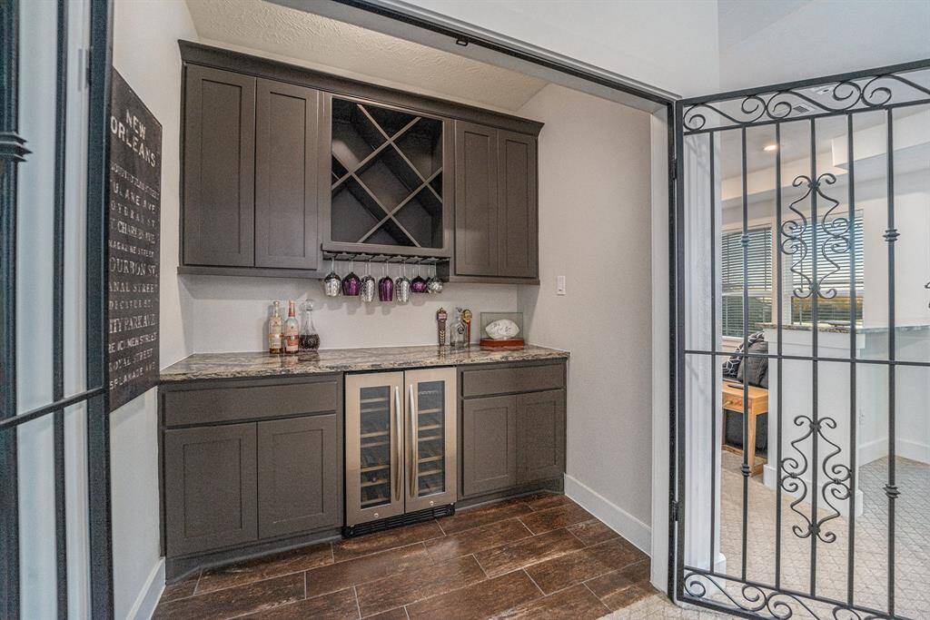 Dry bar, wine fridge, dual zone, upgraded countertops.