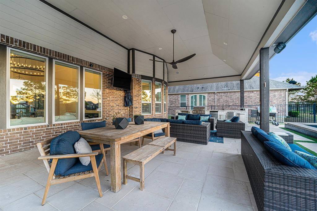 Enjoy serene lake views from every angle of the backyard, enclosed by a rod-iron fence for privacy and tranquility.