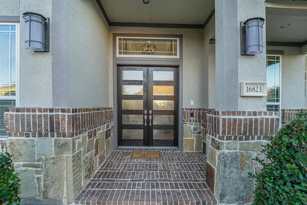 East facing front door. Front Porch with seating area invites you to the grand entry. Step inside to your new retreat.
