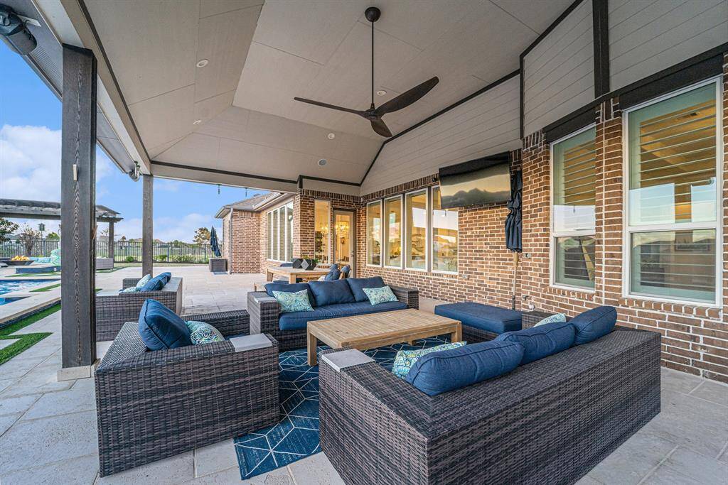 The extended covered patio offers outdoor living and dining for the ultimate entertainment or relaxing retreat experience.  A backyard oasis includes a massive 14-foot hot tub with a waterfall, an oversized pool with a sun deck, a basketball goal, and a fire pit under a grand cabana.