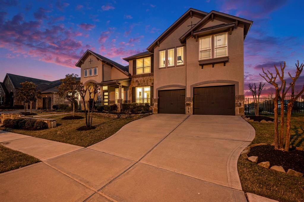 Spacious 3-car tandem garage with freshly epoxied floors, ample storage racks, and entry way into house features cubby system, pre-wired electricity, plugs for devices.