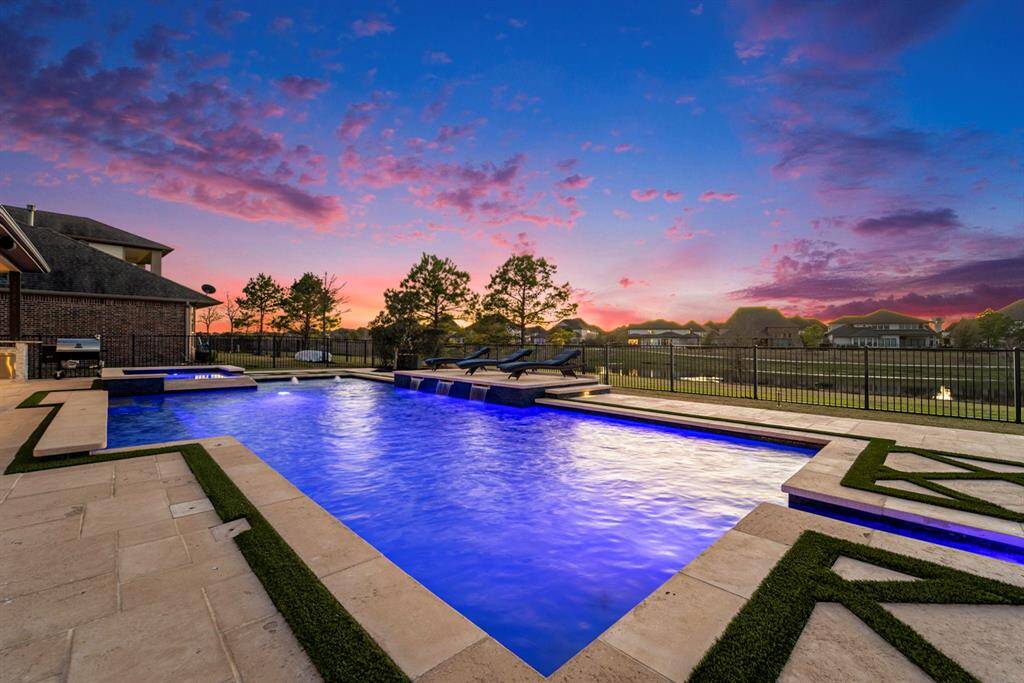 Bask in the sun or take a swim in your refreshing saltwater pool at sunset.  Saltwater oversized resort-style sports pool and hot tub - The backyard oasis includes a massive 14-foot hot tub with a waterfall, an oversized pool with a sun deck, a basketball goal, and a fire pit under a grand cabana.