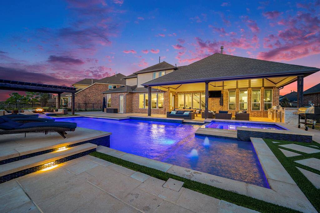 Enjoy serene lake views from every angle of the backyard, enclosed by a rod-iron fence for privacy and tranquility.