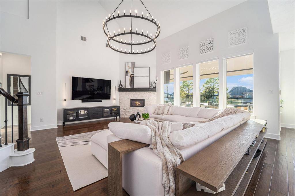Family Room - Custom lighting, 7.1 surround sound, hidden speakers, receiver, modern stone fireplace, fire glass accents.