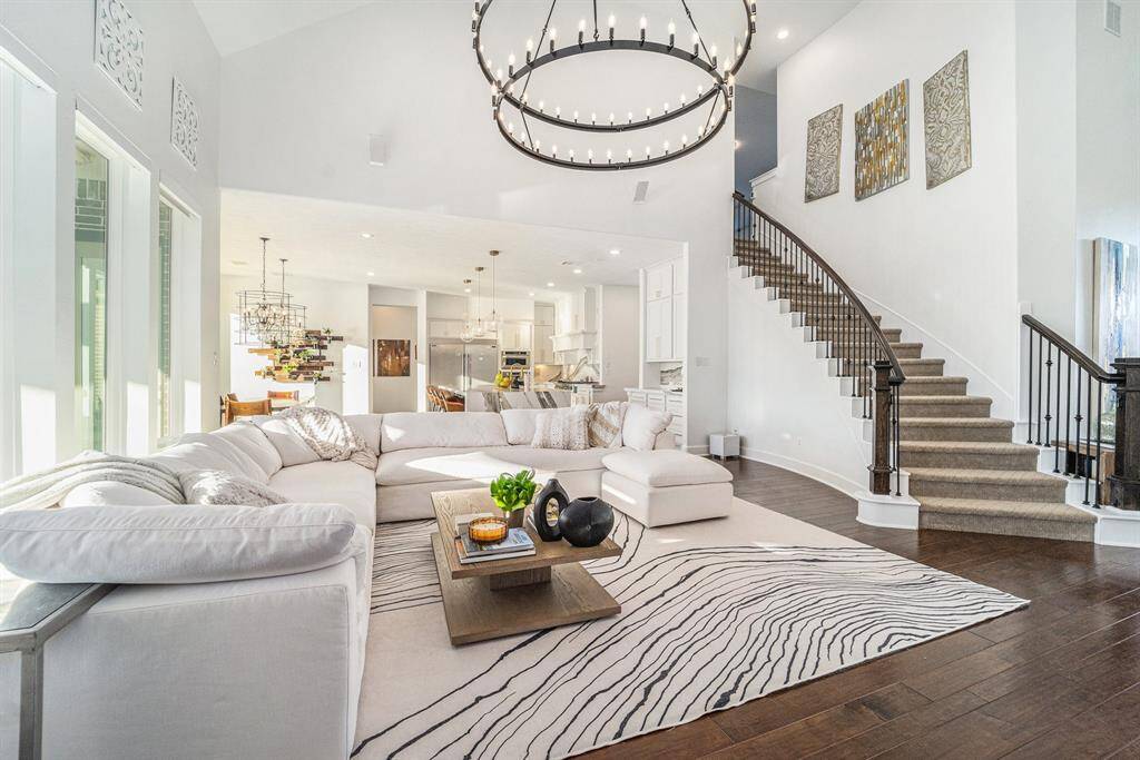Living room boasts natural light throughout with Western sun in afternoons.  Enjoy resort-style pool and water views, grand staircase.