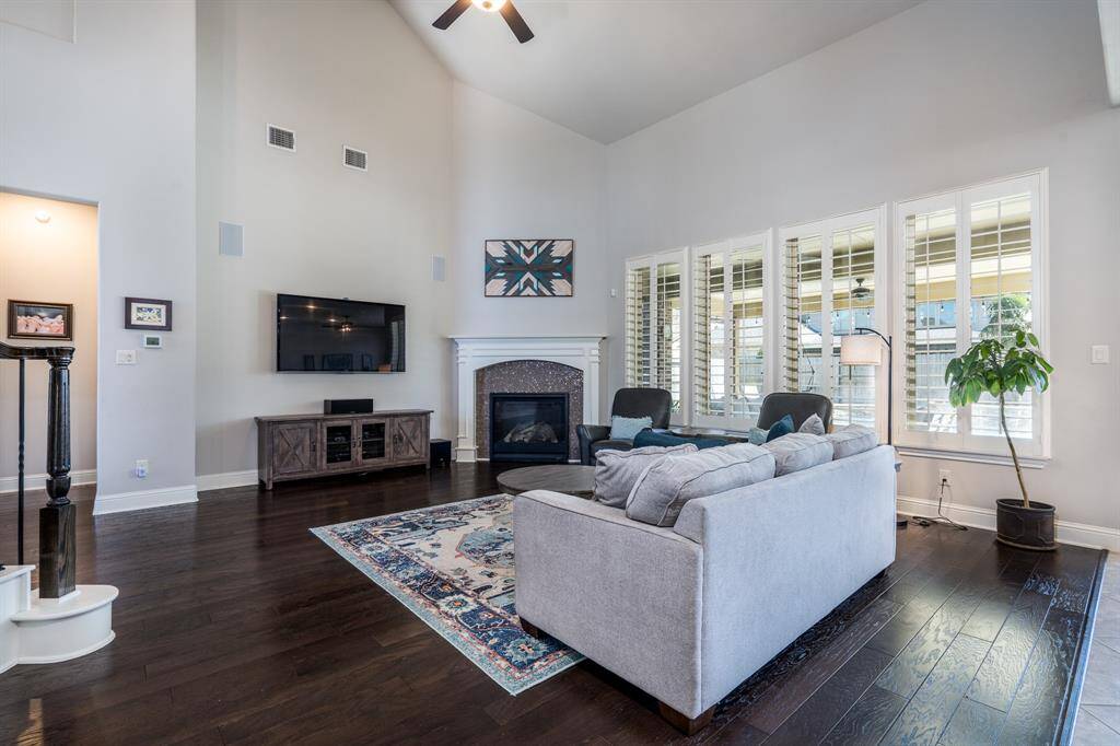This view of the family room showcases the wall of windows and corner fireplace with modern mosaic accents! Also featured are the surround sound in-wall speakers, just right for gatherings of family and friends!