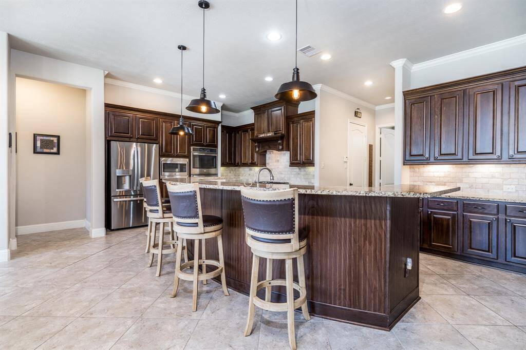 Wow! This is truly an entertainer's kitchen! Imagine friends and family surrounding the HUGE island enjoying a glass of wine while a meal is being prepared!