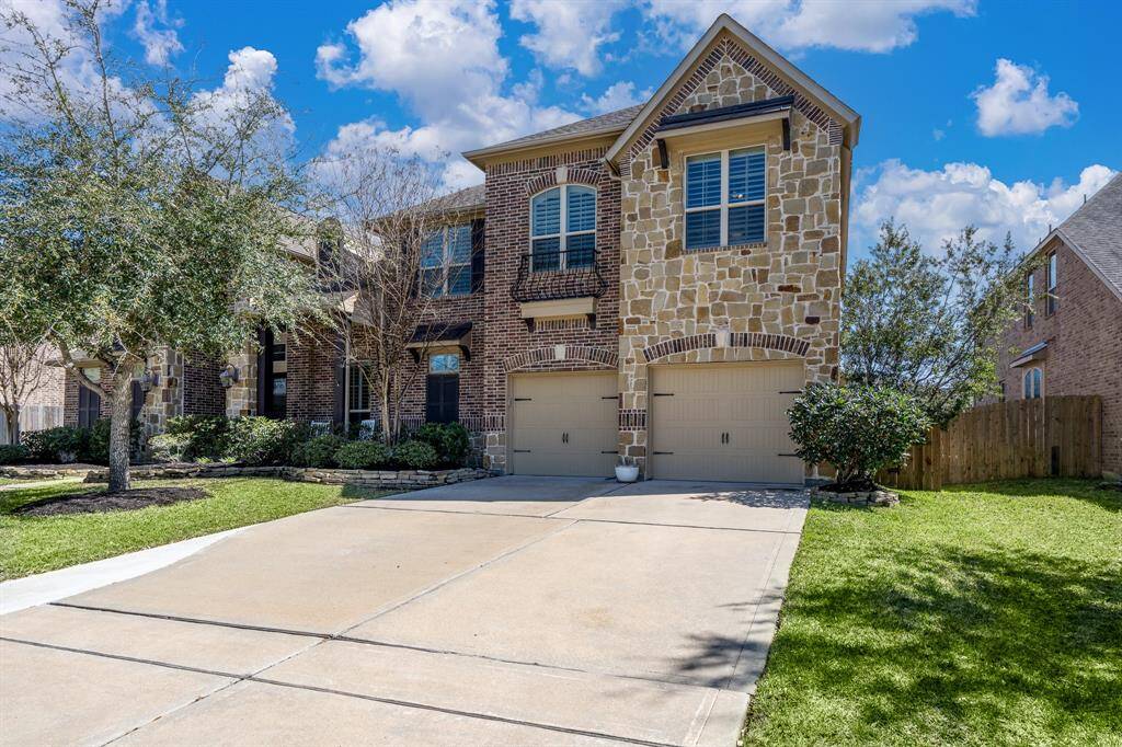 An extra wide driveway adorned with meticulously maintained landscaping offers easy access to the 3 car tandem garage!