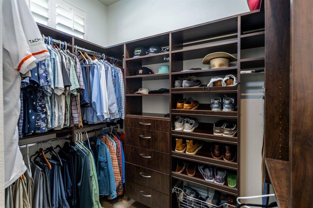 These dual California closets are located right off the primary bath and are separated by a dressing area with full length mirror.