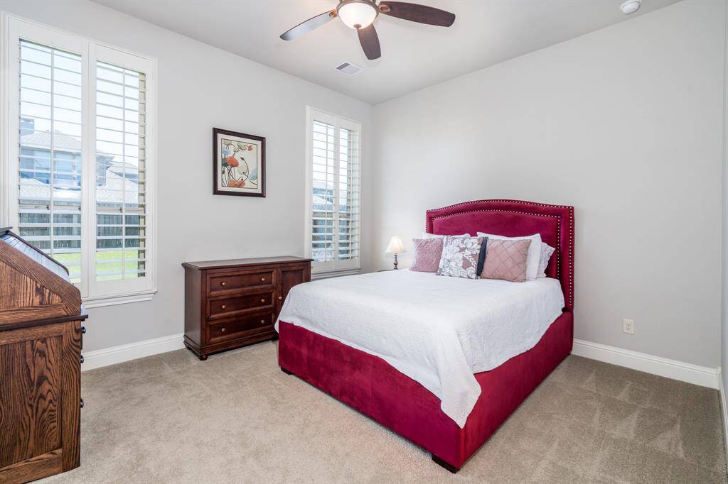 The first of four secondary bedrooms is conveniently located off of the kitchen area on the first floor. With its own private bath, it makes a great mother-in-law suite! This room boasts plantation shutters, ceiling fan, and soft, neutral carpet!