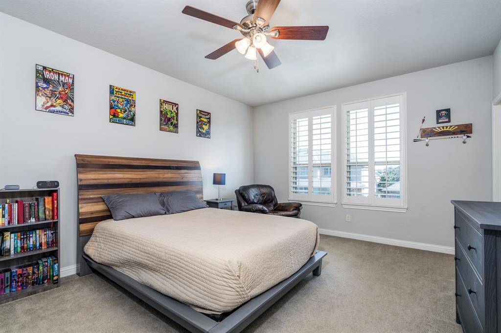 The third of four secondary bedrooms featuring neutral paint and carpet, ceiling fan, plantation shutters and walk in closet! This bedroom also has its own vanity and connects to the Jack n Jill bath.