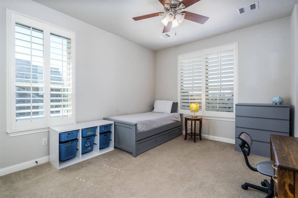 The fourth of four secondary bedrooms offers neutral paint and carpet, plantation shutters, ceiling fan and walk in closet. If movies are your thing, this room can easily be transformed into a media room!