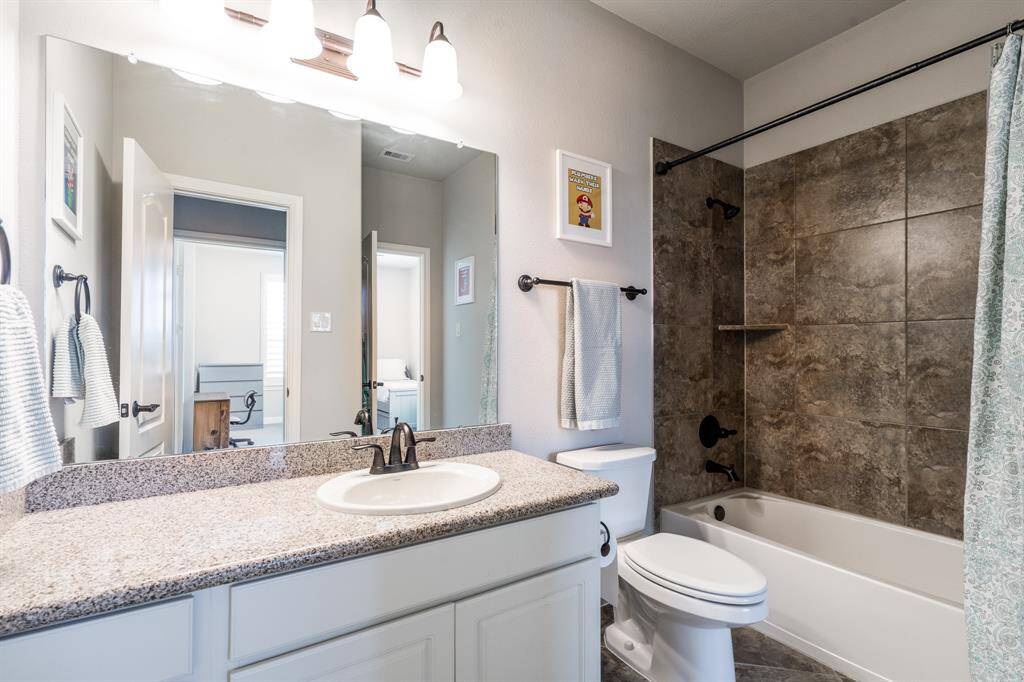 Located off of the game room is this full bath with granite countertops and plenty of vanity storage. This bath is also accessible from the fifth bedroom.