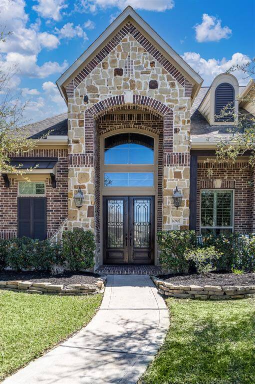 Stone and brick elevation with beautiful, stacked stone landscape welcome all who enter!